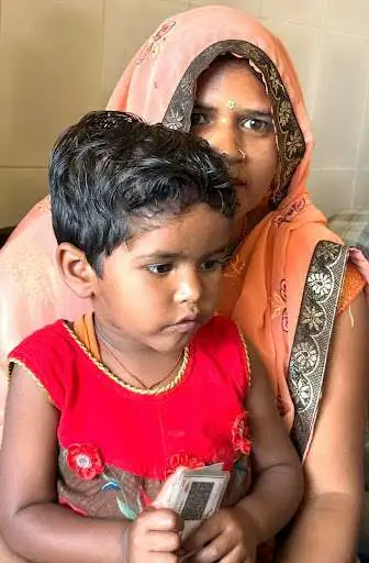 Indian mother and child holding currency notes