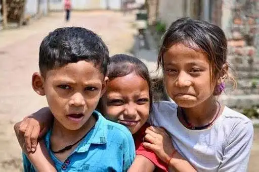 Three rural Indian children smiling together