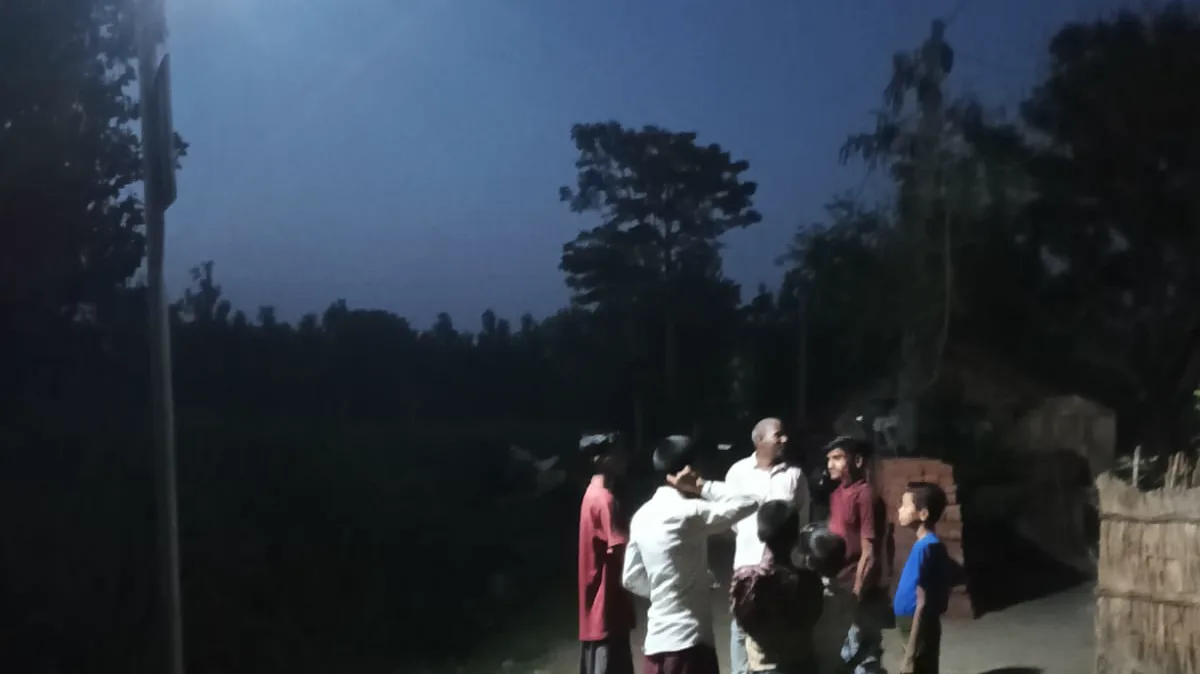 A community gathering lit by a solar street light