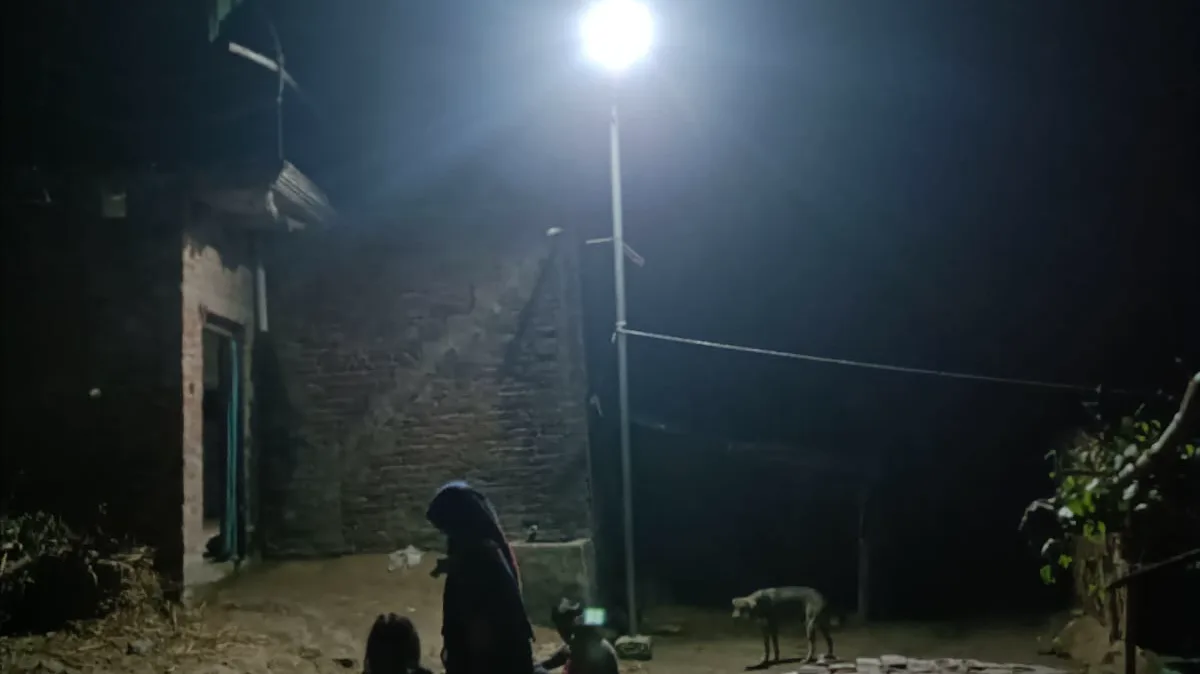 A village street lit at night by a Solar Village street light