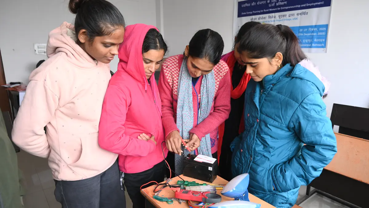 Solar trainees working on a panel array during fieldwork